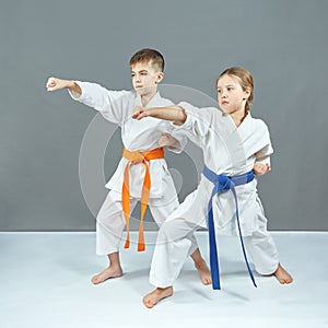 Children are training blow the hand on a gray background