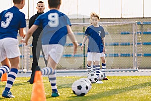 Children Training Football. Young Boys Running with Ball on Training Practice Session