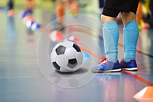 Children training soccer futsal indoor gym. Young boy with soccer ball training indoor football. Little player in light blue sport