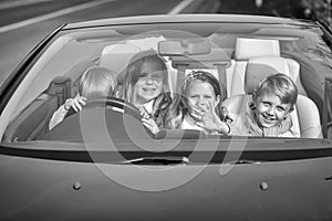 Children travel by car. happy children friends in car