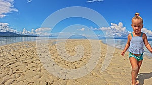 Children of the Triplet Sister play on the beach and in shallow water