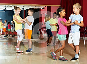 Children trying partner dance in class