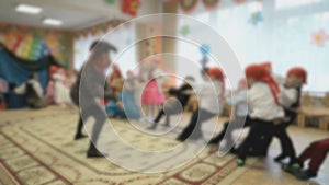 Children tug rope in the hall of the kindergarten