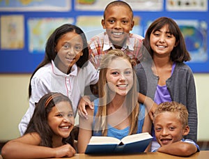 Children, tutor and portrait with group in classroom for knowledge, learning or education with happiness. Face, student