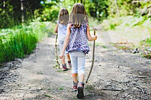 Children - twin girls are hiking in the mountains.