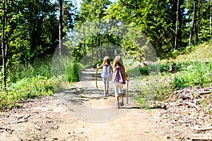 Children - twin girls are hiking in the mountains.