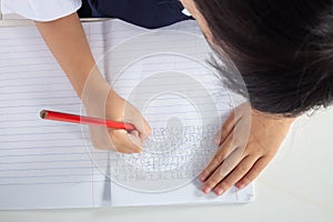 Children in uniform doing homework