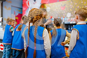 Children in uniform playing salesmen, playroom