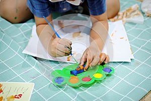 Children use watercolor brushes to create imagination and enhance their learning skills.