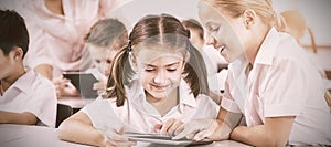 Children using digital tablets in classroom