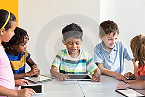 Children using digital tablets in classroom