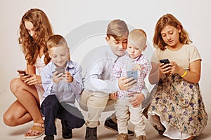 Children using electronic gadgets as a symbol of dependence on s