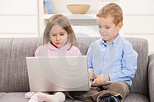 Children using laptop at home