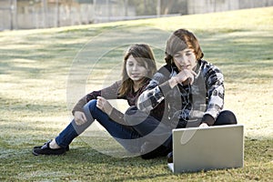 Children using laptop in park