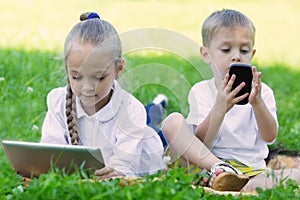 Children using tablet PC and smartphone