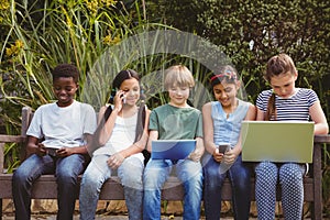 Children using technologies at park