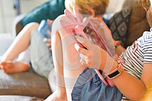 Children using their tablet device to play computer games and use educational apps