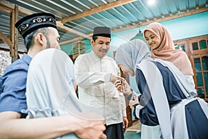 children visiting their parent and shake hand on idul fitri