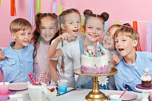 Children waiting the process of cutting birthday cake