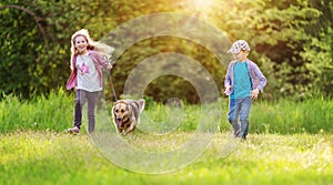 Children walking with a dog in nature