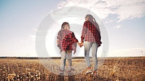 Children walking in the park holding hands. kid dream happy family concept. children walking in nature outdoors sunlight