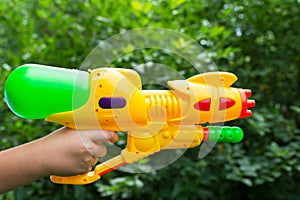 Children water gun in children's hand