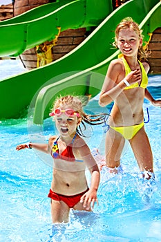 Children on water slide at aquapark.