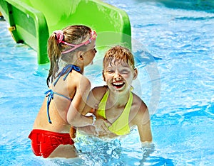 Children on water slide at aquapark.