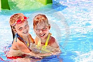 Children on water slide at aquapark.