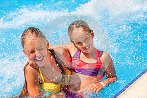 Children on water slide at aquapark.