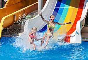 Children on water slide at aquapark.