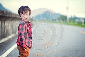 Children wear Jacket to traval and stand in the park.