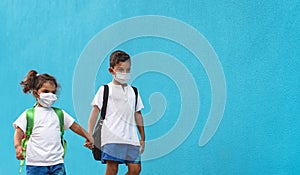 Children wearing face protective mask going back to school during corona virus pandemic