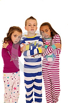 Children wearing pajamas with a freezing cold expression