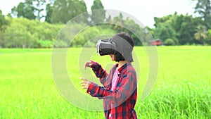 Children wearing virtual reality glasses, kids playing and learning outdoor on green rice field background