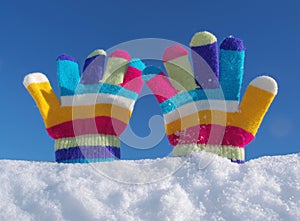 Children winter gloves in snow