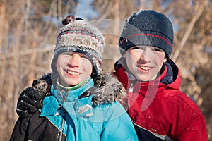 Children in winterwear laughing while playing in snowdrift