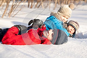 Children in winterwear playing in snowdrift