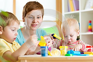 Children and woman with colorful plasticine