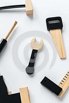 Children wooden instruments on a white  background, hexagon key in the center of the composition. The concept of diy