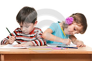 Children write at the desk