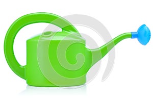 Children's plastic watering can for playing in the sandbox or in the garden. Green watering can isolated on a white