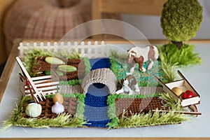 children's play knitted farm. Child's Hands Playing in Garden