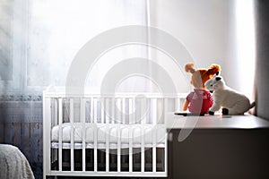 Children& x27;s room with an empty cradle and toys on the dresser. Copy space.Concept of abortion and female infertility photo