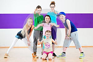 Kids train Zumba fitness in dancing school photo