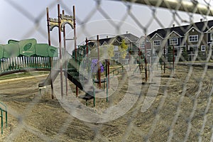 Childrend playground under construction behind a fence photo