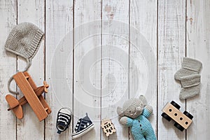 Childrens background, baby toys and shoes, wooden plane and car, layout on wooden background, happy mothers day