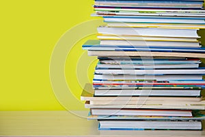 Many childrens books are stacked on top of each other. Green ba photo