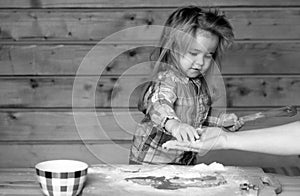 Childrens cook. Little child at kitchen cooking and playing with flour.