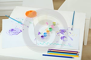 Childrens creativity on the table with paints, photo